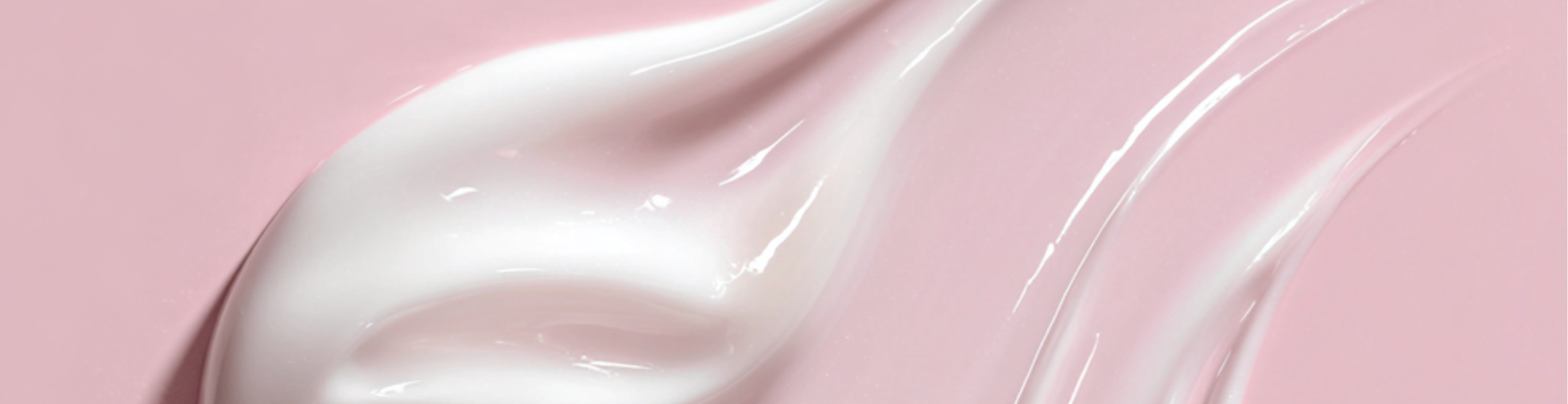 White cream or lotion with a pink background